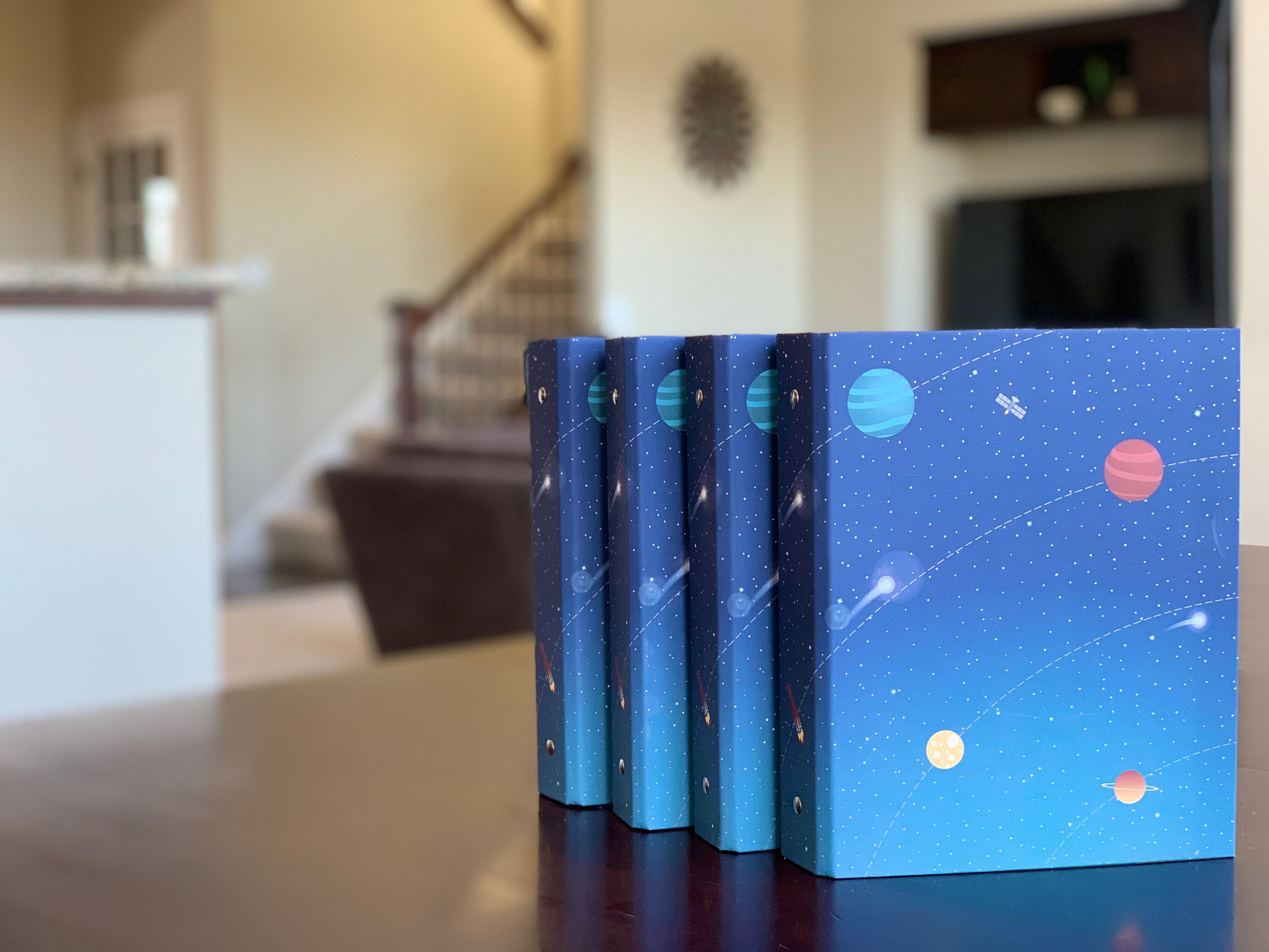 Money management binders for kids lined up on table